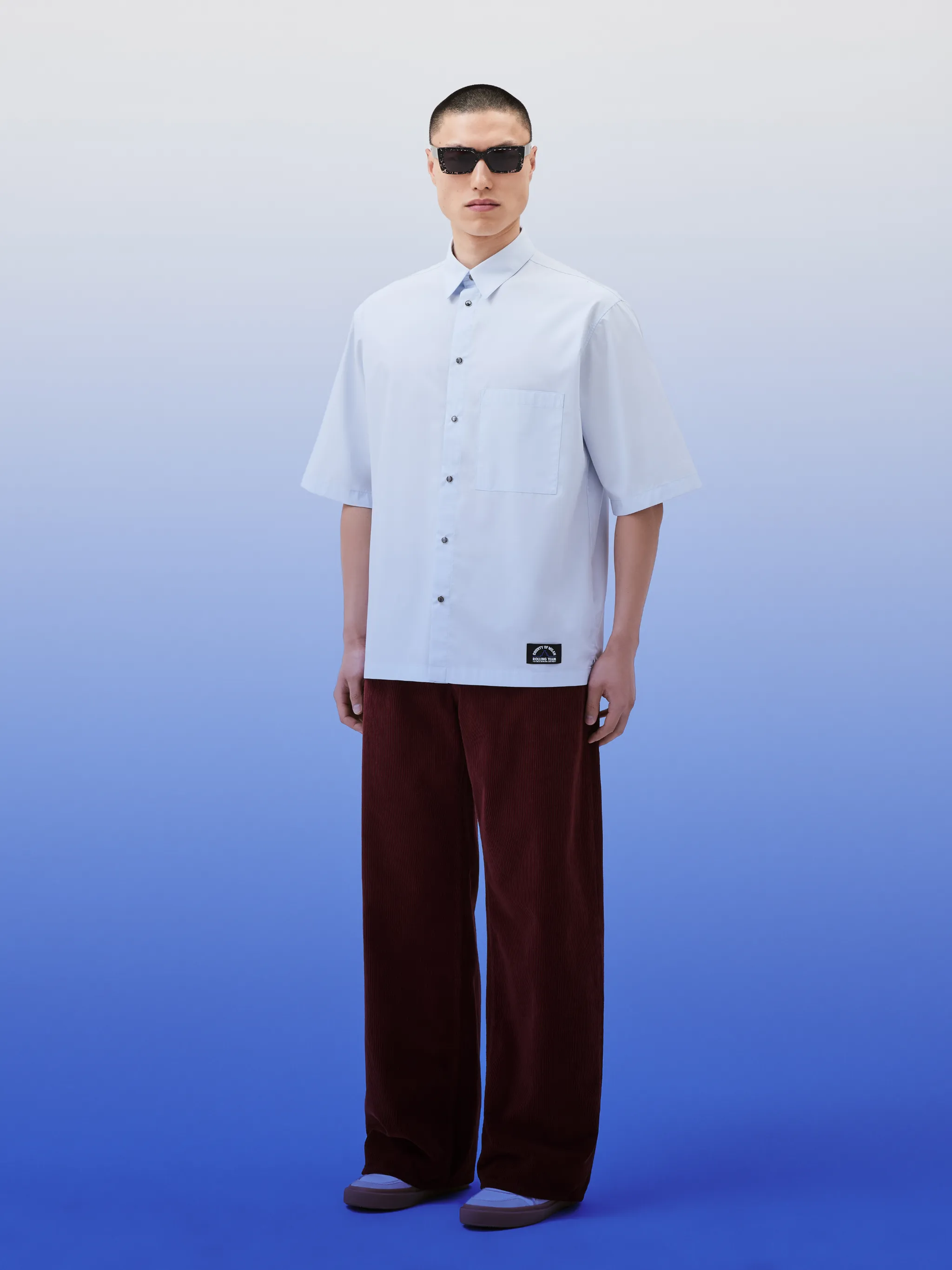 Langosta bowling shirt from Marcelo Burlon County of Milan featuring cotton, logo patch to the front, logo print to the rear, graphic print to the rear, classic collar, front button fastening, short sleeves, chest patch pocket and light blue/black.