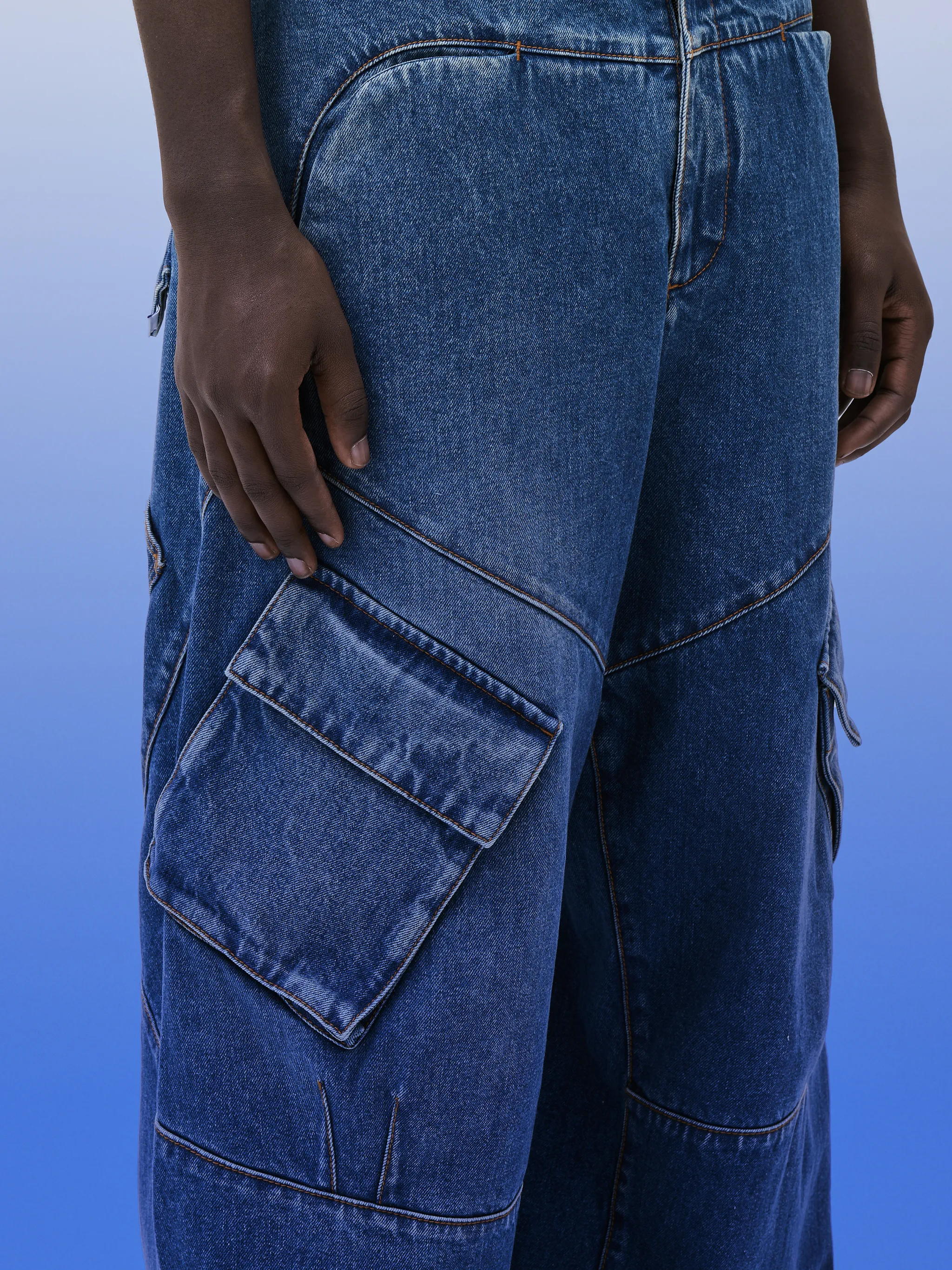 wide-leg cargo jeans from Marcelo Burlon County of Milan featuring indigo blue, cotton blend, denim, logo patch to the rear, mini logo tag, wide leg, belt loops, button fly fastening and multiple cargo pockets.