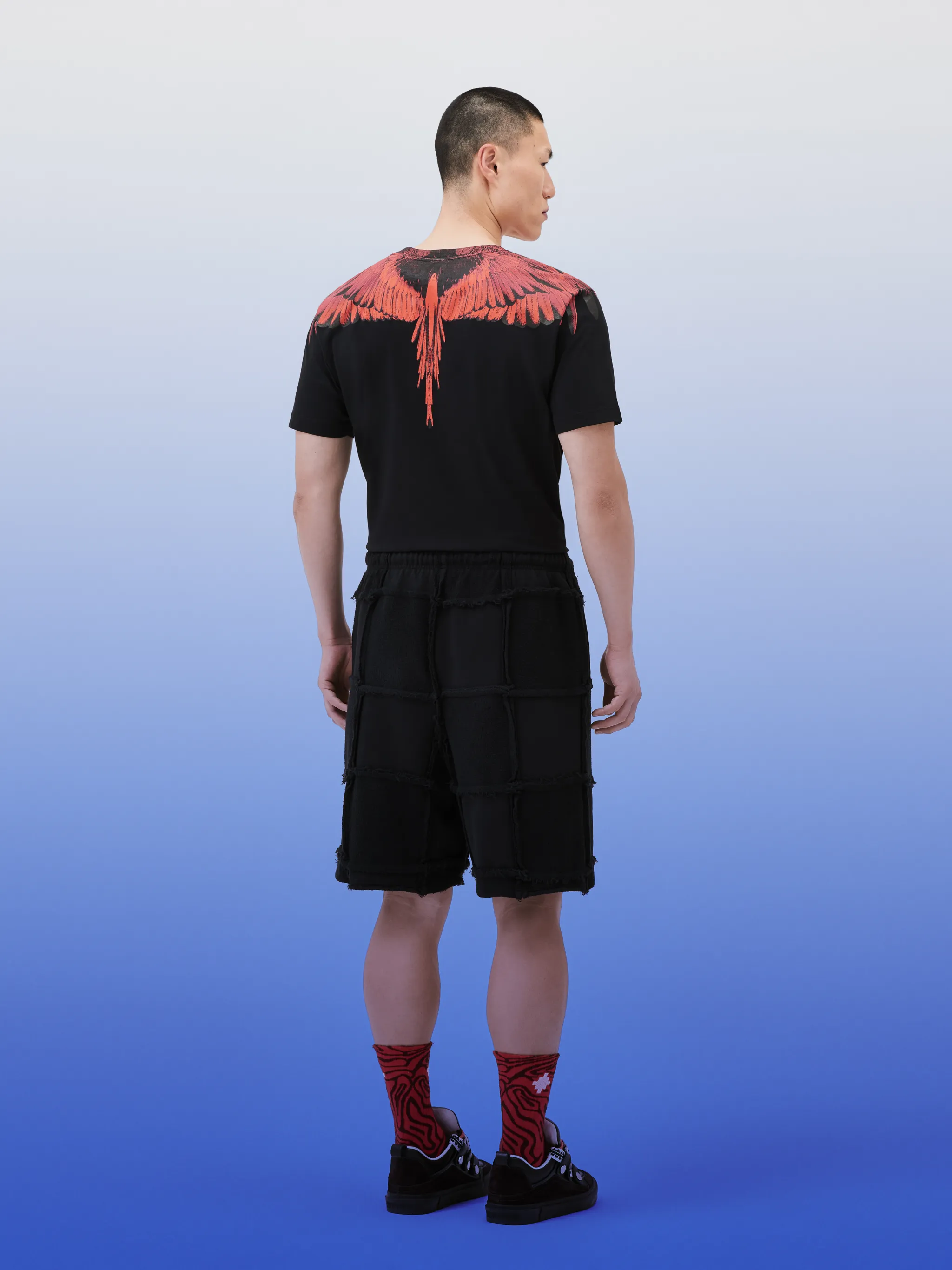 Cross Inside Out cotton track shorts from Marcelo Burlon County of Milan featuring jet black, organic cotton, embroidered logo to the side, exposed-seam detailing, elasticated drawstring waistband, two side slit pockets, straight hem and knee-length.