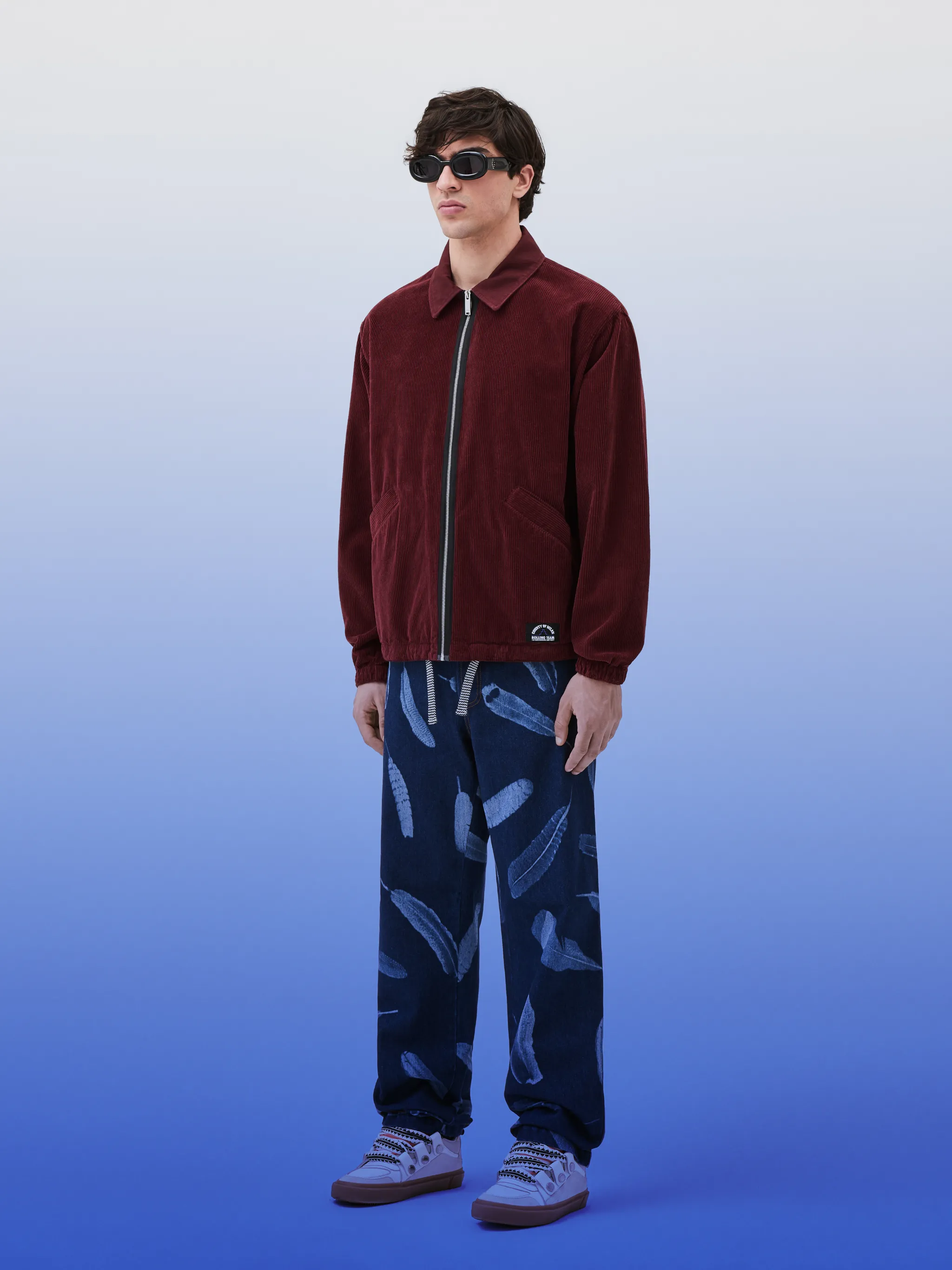County Label corduroy jacket from Marcelo Burlon County of Milan featuring clay red, cotton, corduroy, logo print to the rear, logo patch to the front, classic collar, front zip fastening, long sleeves, two diagonal pockets to the sides and drawstring hem.