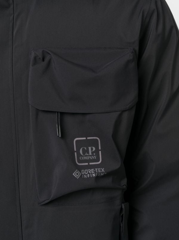 C.P. Company logo-print two-pocket Windbreaker - Farfetch