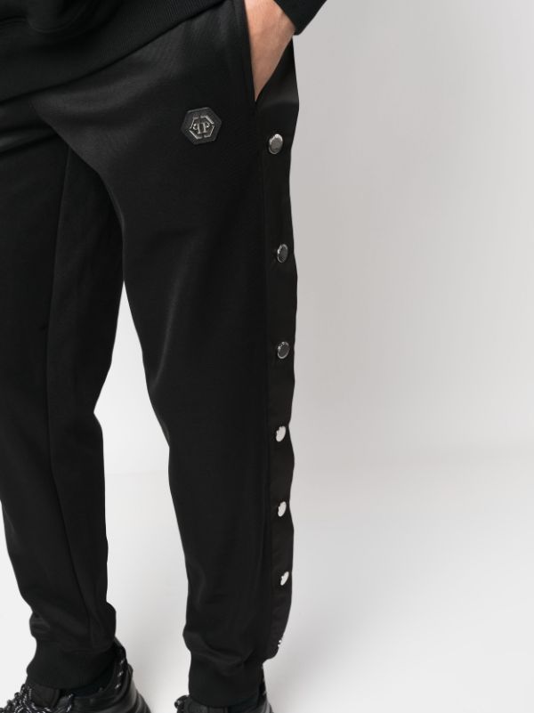 Track pants with top buttons on the side