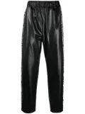 Junya Watanabe Comme des Garçons Pre-Owned x Keith Haring graphic-print track pants - Black