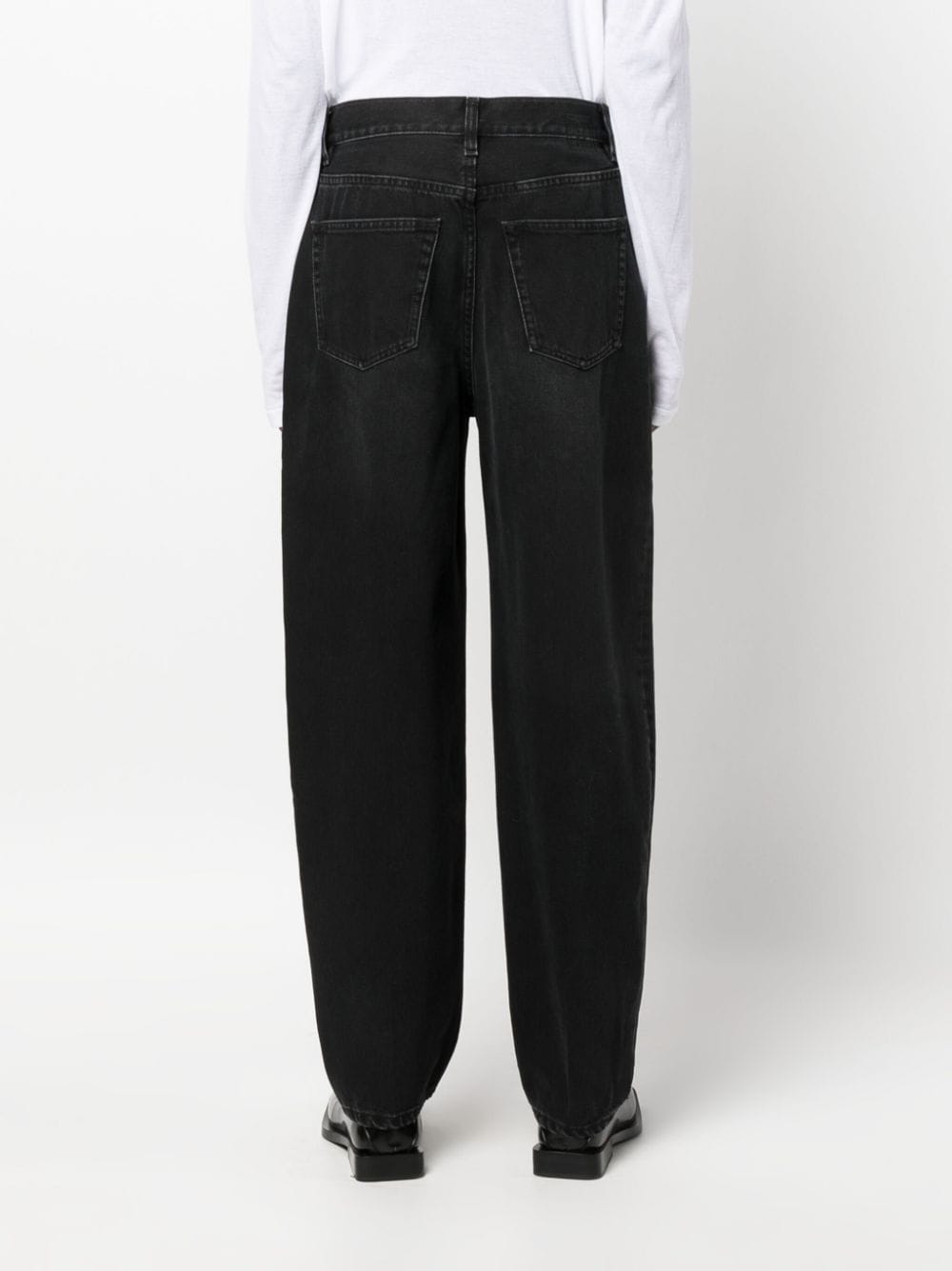 Shop Totême Faded-effect Tapered-leg Jeans In Black