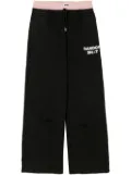Natasha Zinko layered logo-print trousers - Black