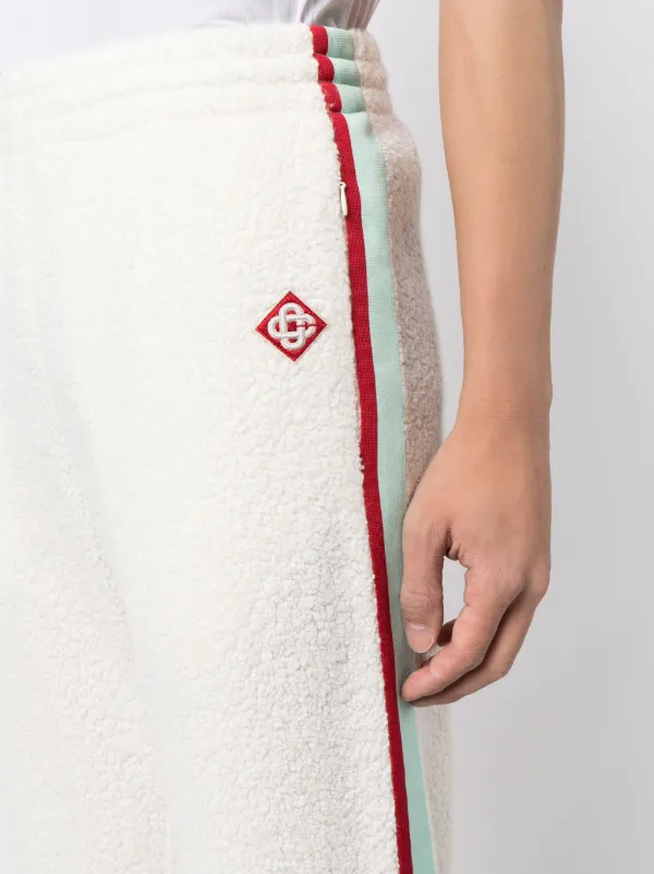 White track pants shop with red stripe