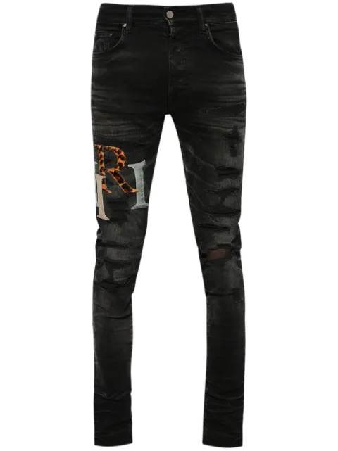 AMIRI logo-patch distressed skinny jeans
