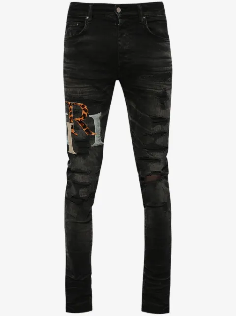 AMIRI logo-patch distressed skinny jeans