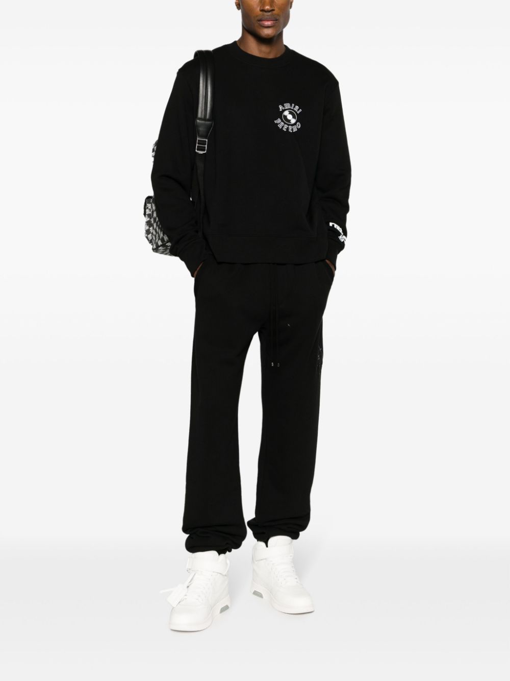 Shop Amiri Staggered Logo-embroidered Track Pants In Black