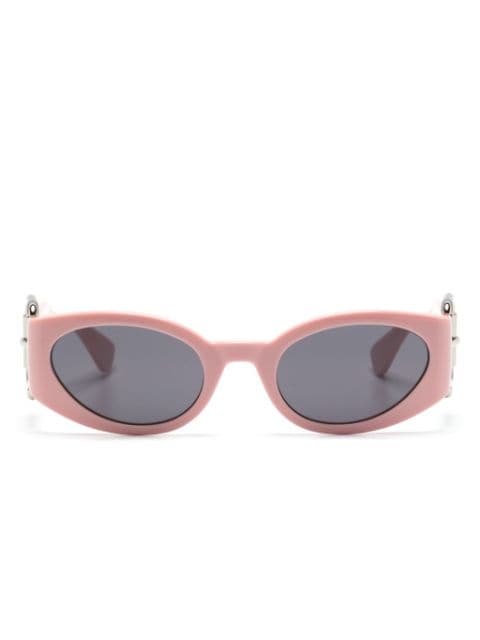 Moschino Eyewear lentes de sol con armazón ovalada y detalle de hebilla