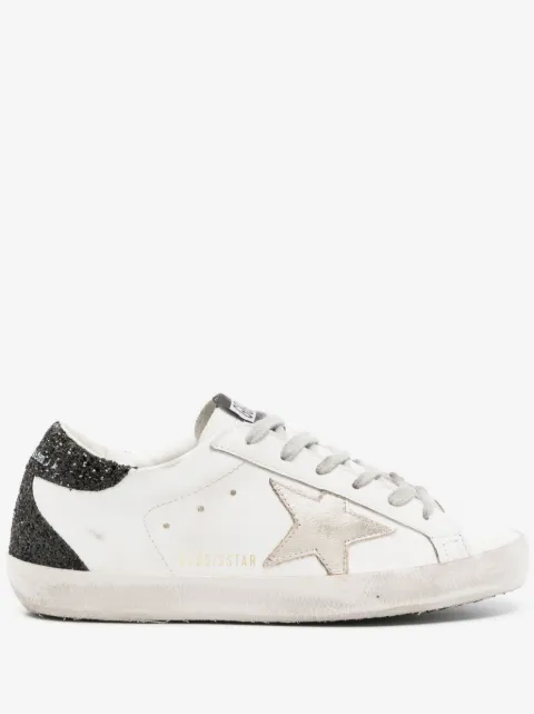 Golden Goose Super-Star trainers with gold star and black glitter heels tab