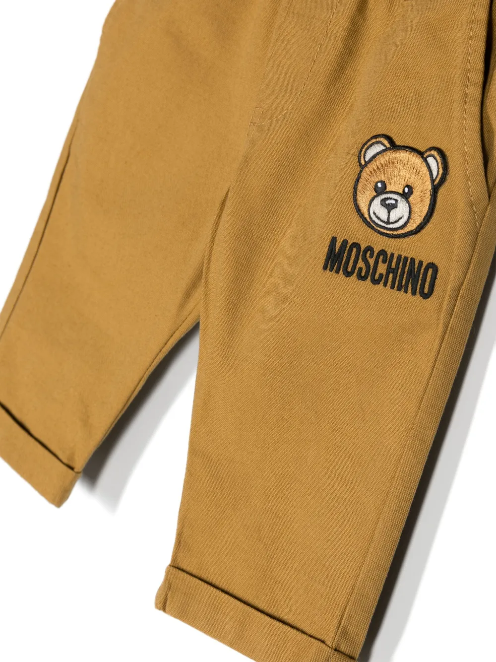 Shop Moschino Teddy Bear-patch Mid-rise Chino Trousers In 20327 - Marrone