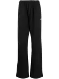 We11done logo-print track pants - Black