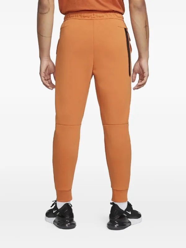 Nike テックフリース ジョガーパンツ | オレンジ | FARFETCH JP