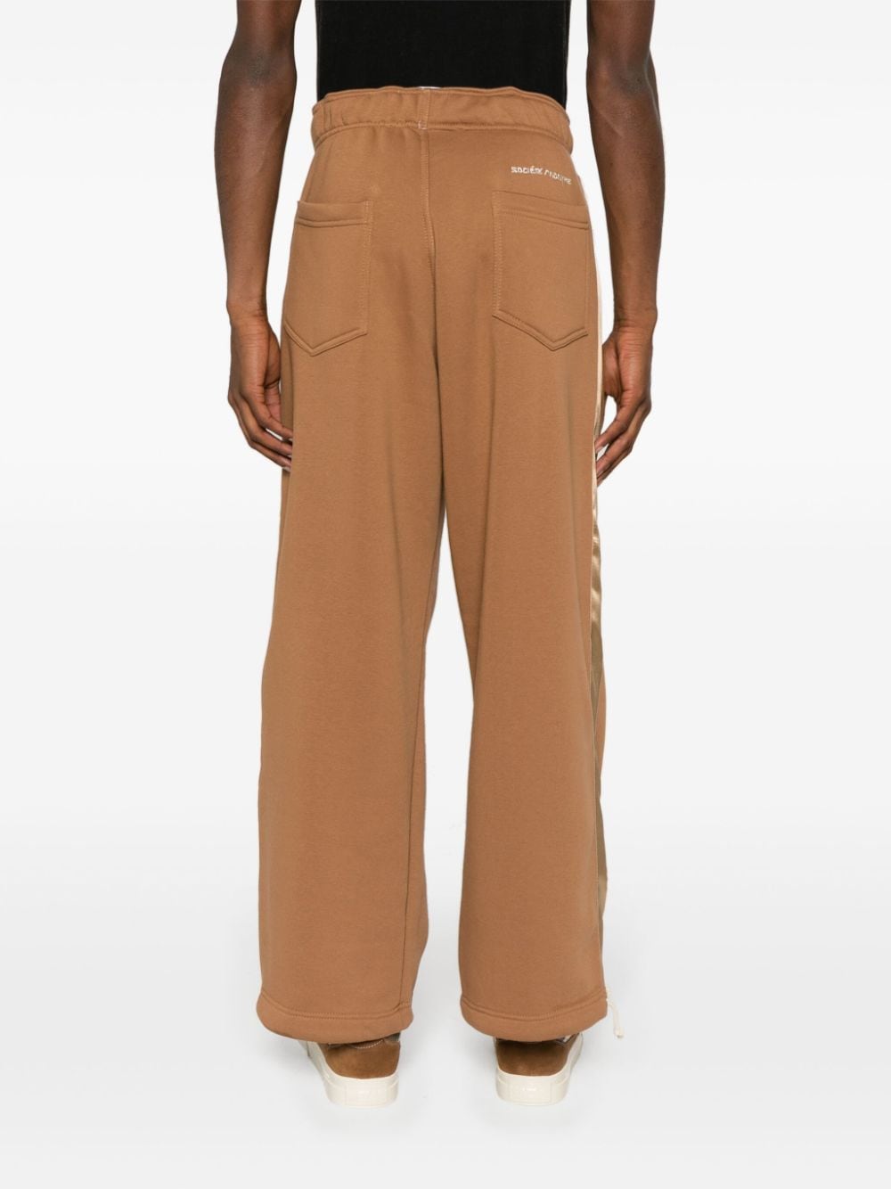 Shop Société Anonyme Logo Embroidered Satin Trim Trousers In Brown