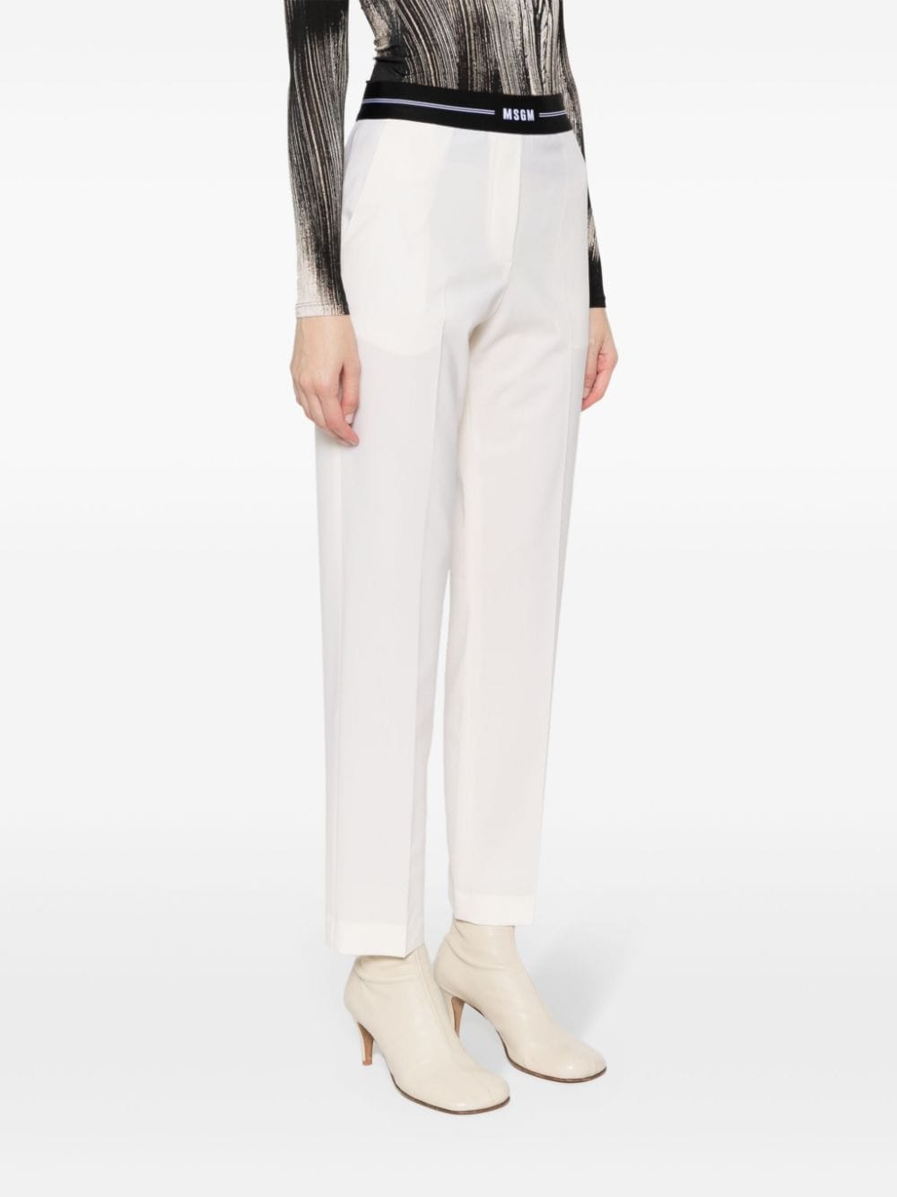 Shop Msgm Logo-waistband Tapered Trousers In Neutrals