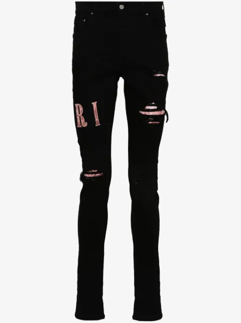 AMIRI waxed logo-appliqué skinny jeans