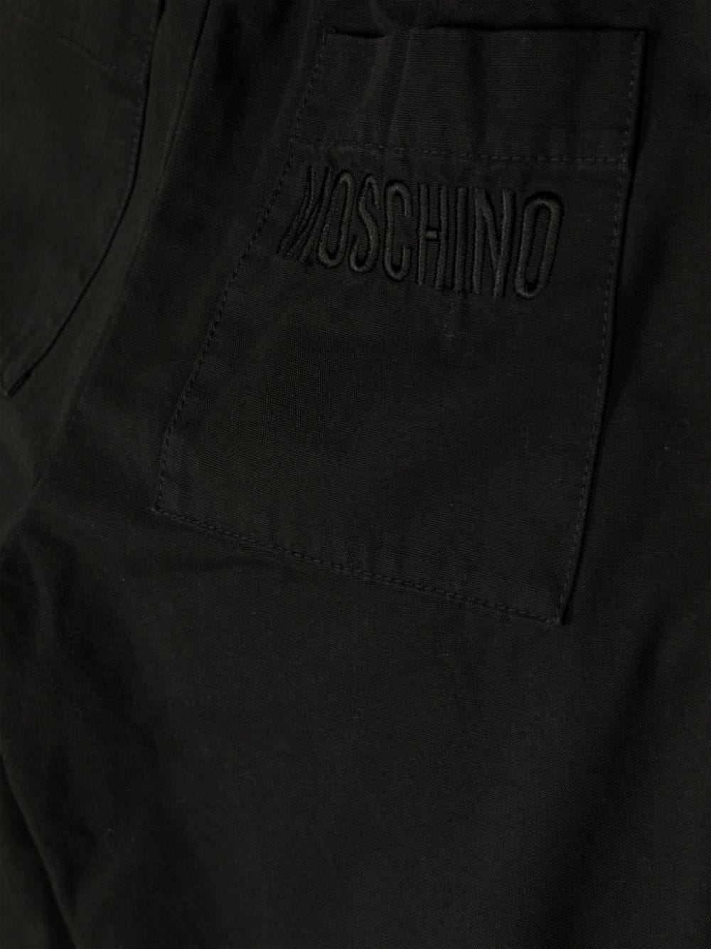 Shop Moschino Pleated Tapered Trousers In Black