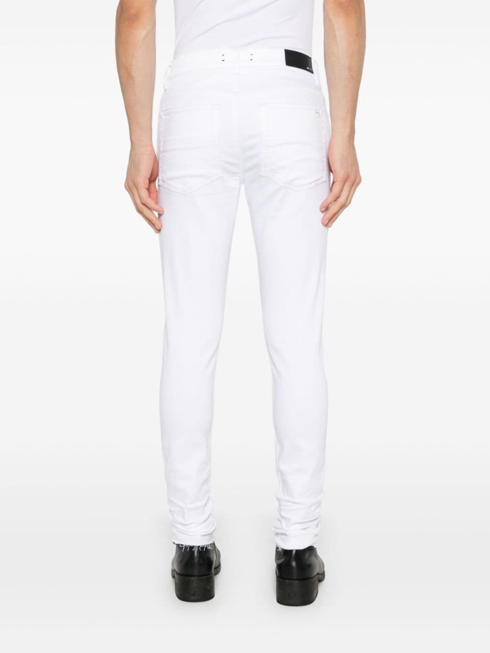 Shop Amiri Released Hem Skinny Jeans In White