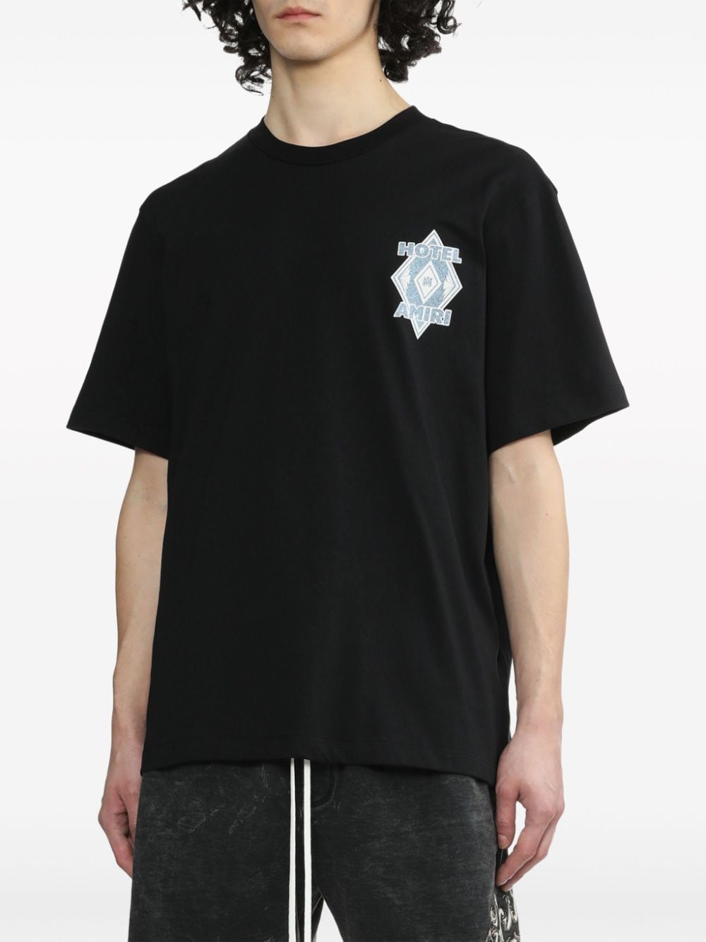 Shop Amiri Graphic-print Cotton T-shirt In Black