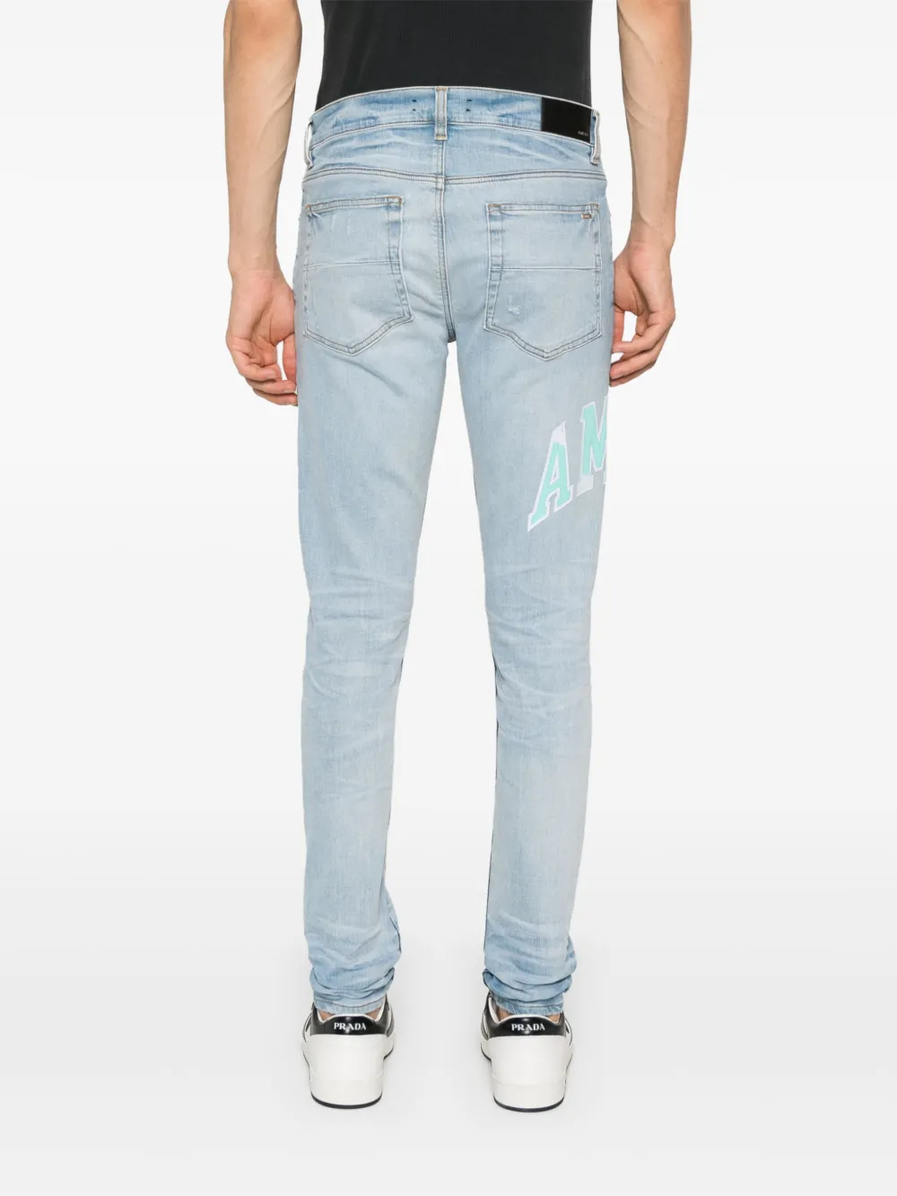 AMIRI VARSITY LOGO SKINNY JEANS
