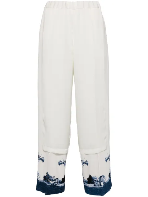 Undercover pantalones con paneles y estampado gráfico