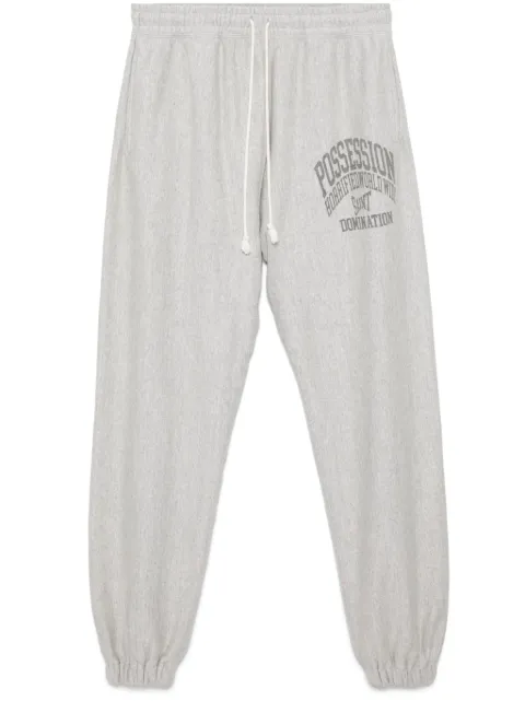 SAINT MXXXXXX slogan-printed track pants