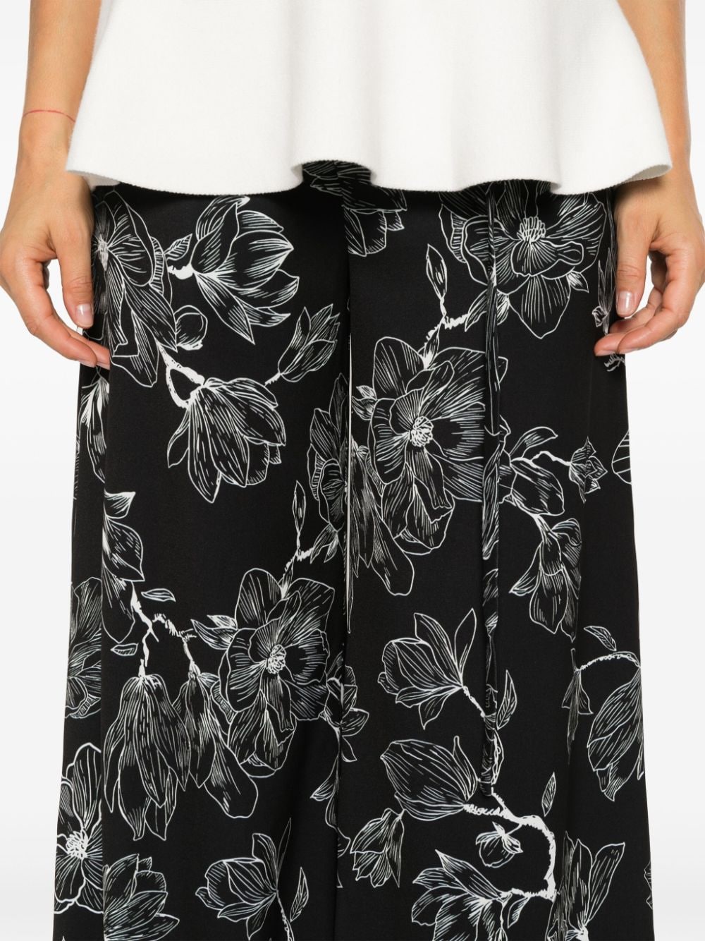 Shop Les Filles D'eva Floral-print Trousers In Black