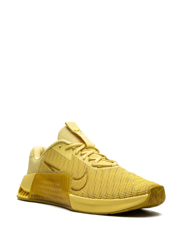 gold color nike shoes