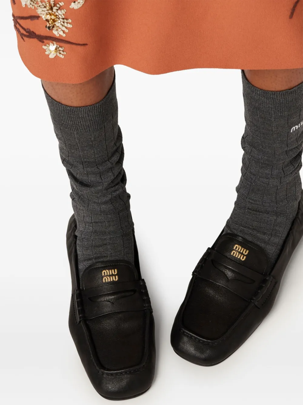 Miu embossed-logo loafers Black