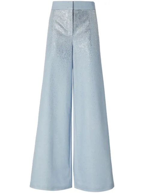 Genny jeans acampanados con apliques de strass