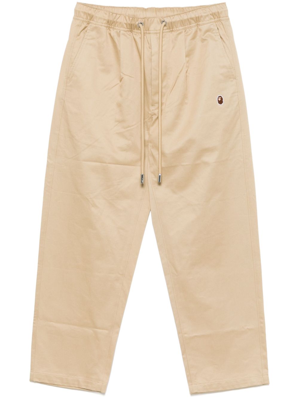 A BATHING APE Asymmetrische broek met apenkop Beige