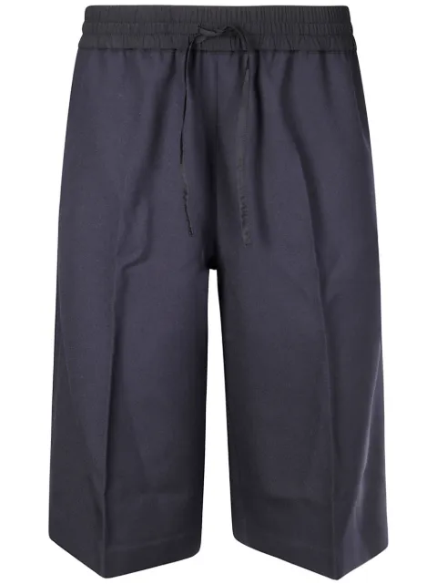 Studio Nicholson bermudas con bolsillos
