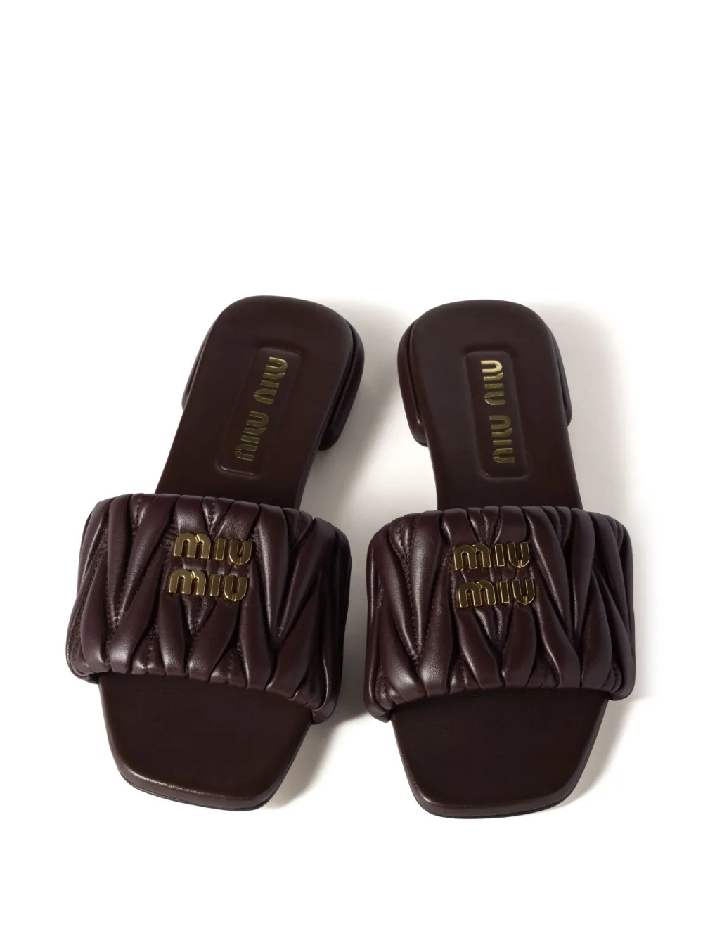 Miu matelassé leather slides Brown