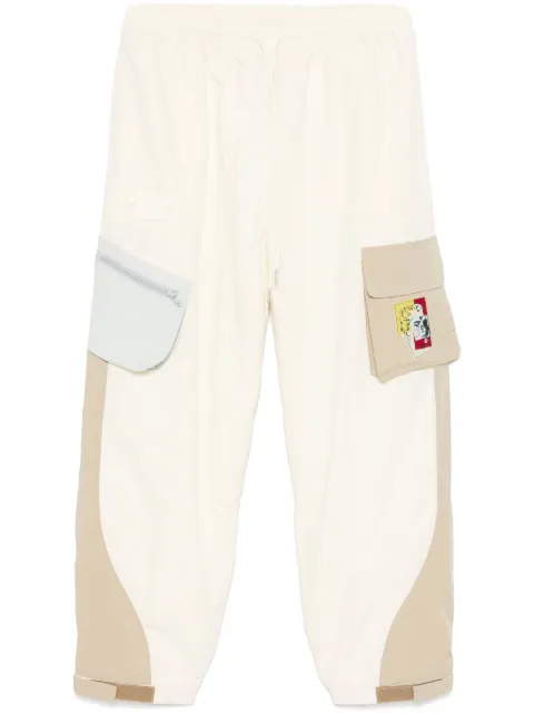 KidSuper logo-patch trousers