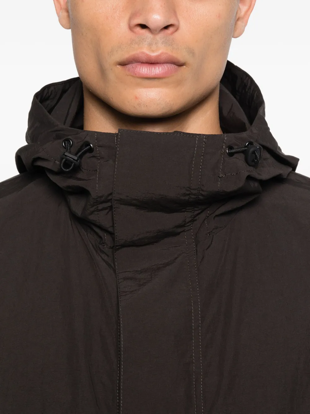 Studio Nicholson Windjack met capuchon Bruin