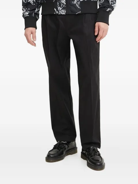 Versace Jeans Couture logo-appliqué pleat-detail trousers