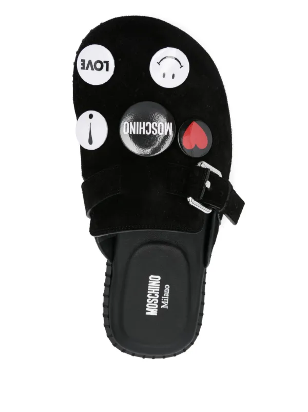 Moschino brooch-embellished Slippers | Black | FARFETCH