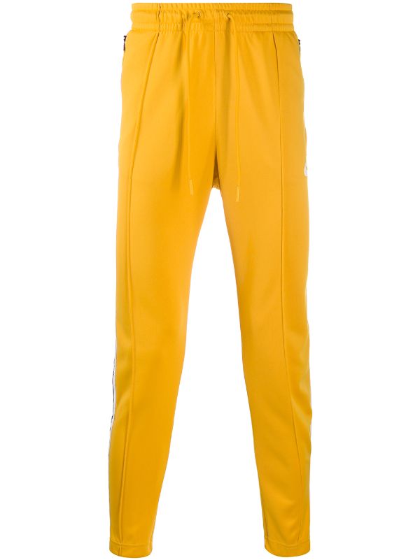 nike track pants yellow