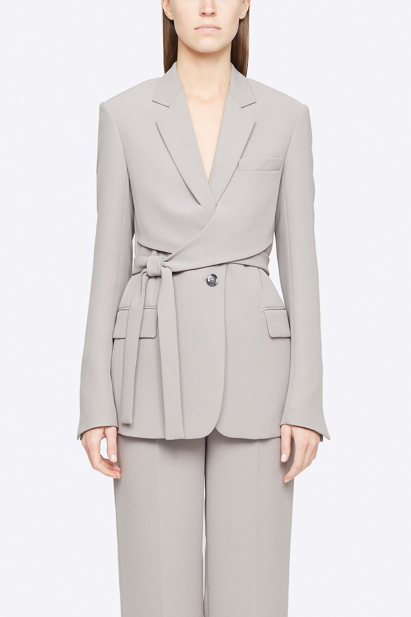 Heavy Cady Wrap Blazer-grey #0 Heavy Cady Wrap Blazer, Grey single-breasted wrap blazer from 3.1 PHILLIP LIM featuring notched lapels, front button fastening, long sleeves, jetted chest pocket, side tie fastening, central rear vent and two front flap pockets. POSITIVELY CONSCIOUS: This product is made with a material widely recognised as being better for the planet, so you can be confident you are choosing positively .- 0