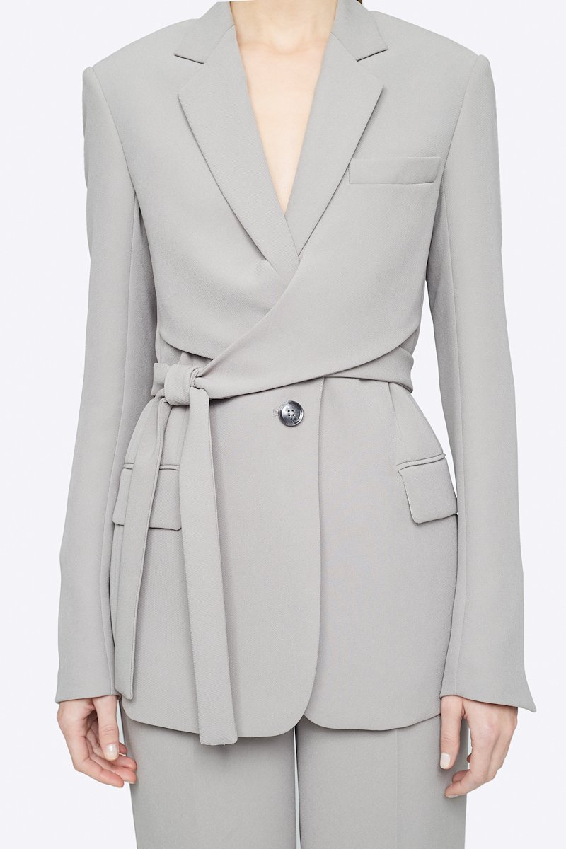 Heavy Cady Wrap Blazer-grey #1 Heavy Cady Wrap Blazer, Grey single-breasted wrap blazer from 3.1 PHILLIP LIM featuring notched lapels, front button fastening, long sleeves, jetted chest pocket, side tie fastening, central rear vent and two front flap pockets. POSITIVELY CONSCIOUS: This product is made with a material widely recognised as being better for the planet, so you can be confident you are choosing positively .- 3