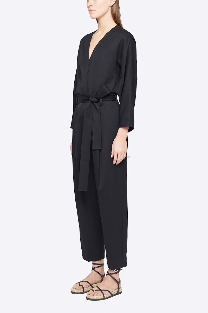 Wool Belted Jumpsuit-black #1 Wool Belted Jumpsuit, Black wool tie-waist wool jumpsuit from 3.1 PHILLIP LIM featuring V-neck, three-quarter length sleeves, buttoned cuffs, tied waist, concealed front button fastening, two side slit pockets, pleat detailing and tapered leg.- 1
