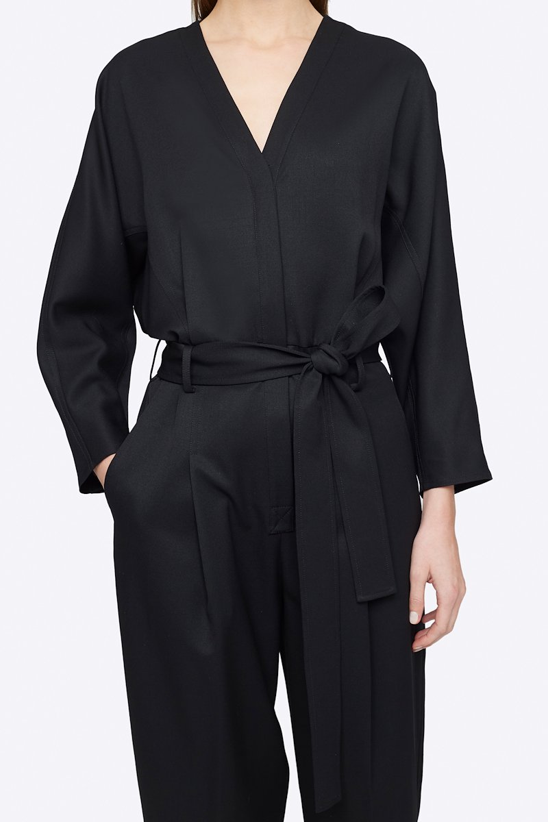 Wool Belted Jumpsuit-black #1 Wool Belted Jumpsuit, Black wool tie-waist wool jumpsuit from 3.1 PHILLIP LIM featuring V-neck, three-quarter length sleeves, buttoned cuffs, tied waist, concealed front button fastening, two side slit pockets, pleat detailing and tapered leg.- 3