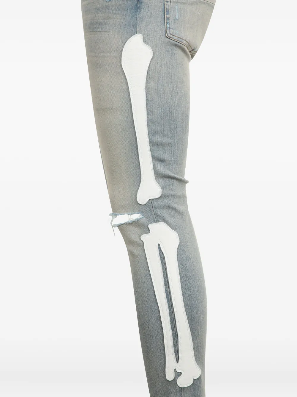 AMIRI Bones-appliqué distressed skinny jeans - Blauw