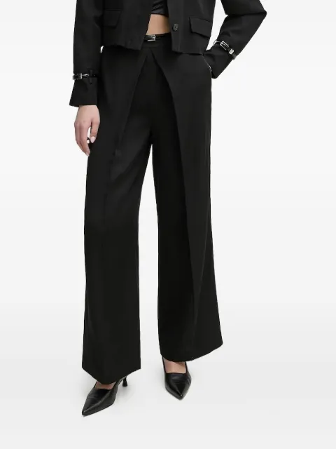 Isabelle Blanche pleated buckle-detail trousers