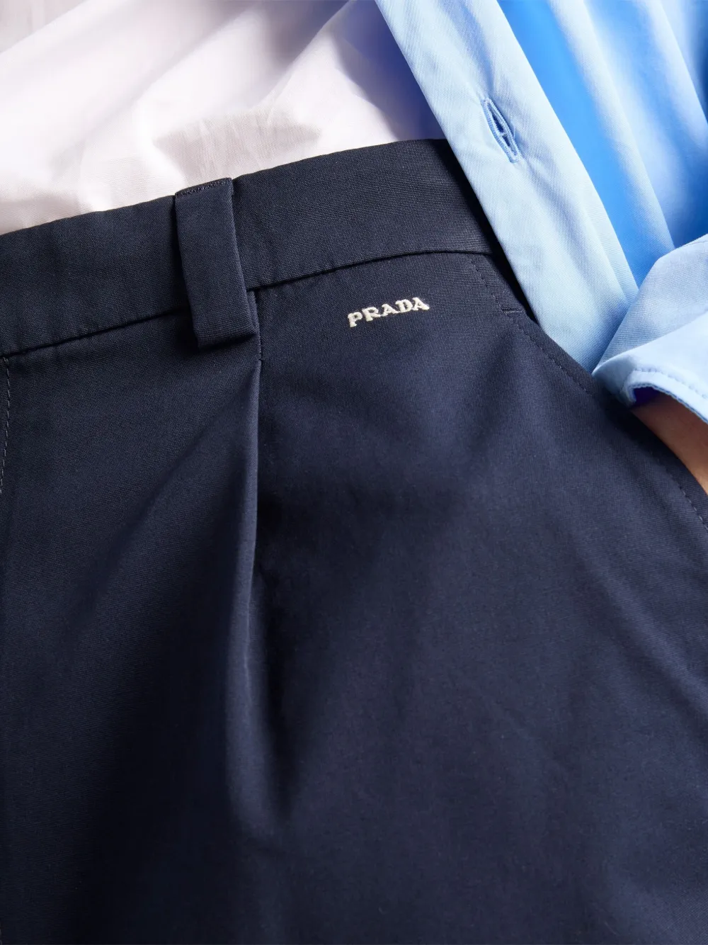 Prada Logo-embroidered Front-pleated Shorts In Blue