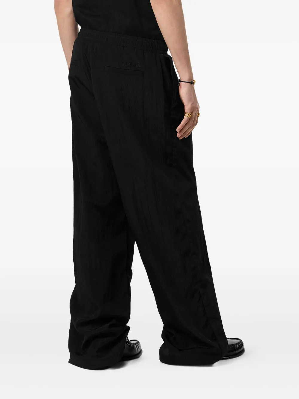 Versace Elasticated-cuff Trousers In Black