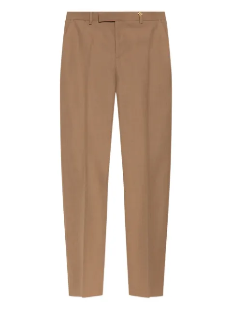 Versace pantalones con botones dorados