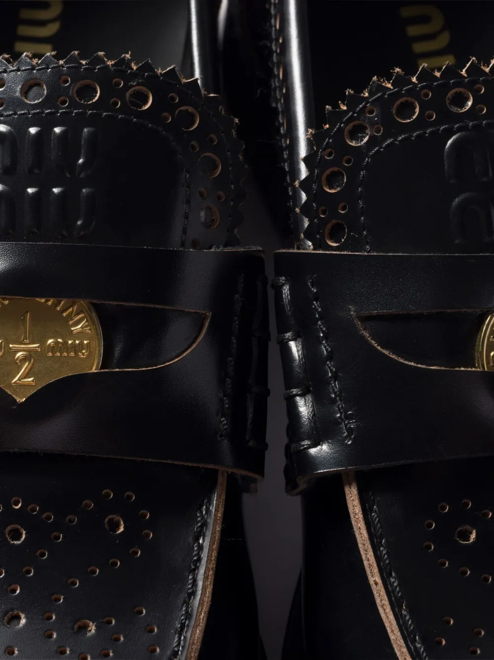Miu perforated coin-detail loafers Black