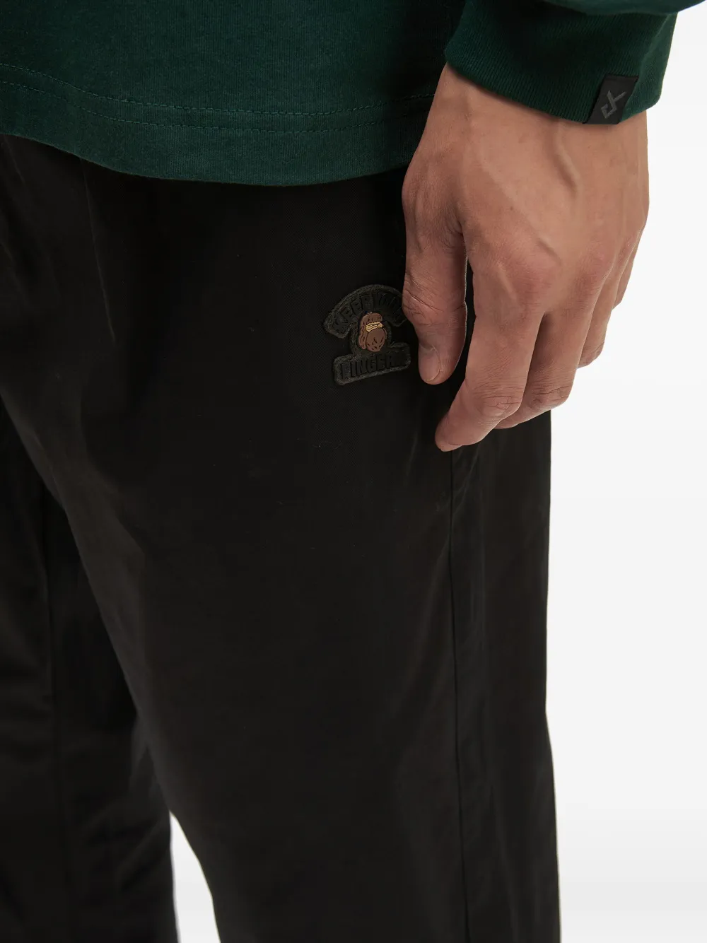 Fingercroxx Logo-patch Cuffed Trousers In Black